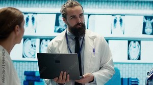 Neuroscience expert reviewing mri brain scan results with doctors, discussing the right treatment plan for disease prevention. Licensed neurologist and his staff examine tomography. Camera A.