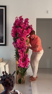 Every piece tells a story. Our one of a kind designs are definite conversation pieces like this oversized handmade teal planter with hundreds of pink vanda orchids arranged in a cascading form. A definite statement piece that you can find in store or online. | cfadesigngroup