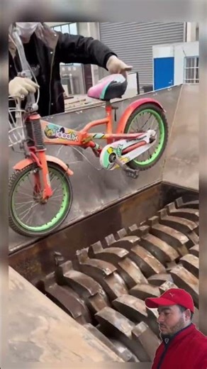 Powerful industrial shredder crushing a metal drum into piece