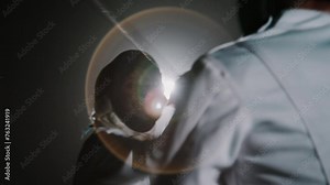 Rear slowmo of unrecognizable fencer fighting with rapier with swordswoman in epee mask during competition in dark foggy room