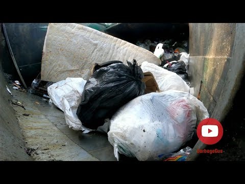 Waste Management garbage truck compacting garbage