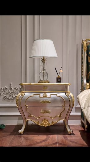 This French-style bedside cabinet features a hand-applied silver-leaf base, softened with subtle gold accents. The curved silhouette, sculpted details, and muted metallic tones create a calm, refined presence in the bedroom. Designed for those who appreciate classic European furniture, but expect modern craftsmanship, smooth drawers, and long-term durability. A quiet luxury piece — meant to be lived with, not rushed past. 👉 Explore more refined bedroom furniture on our website.https://rtfurnish