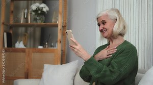 Happy mature senior old granny woman video calling looking at camera communicate in internet, cheerful grandmother talking laughing enjoy online conversation, smiling retired lady holding smartphone