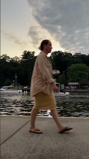 Festive boats parade along Kalamazoo River during Saugatuck Venetian Festival