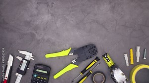 Construction tools moving on bottom of dark theme. Stop motion