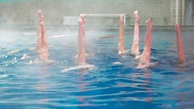 Synchronized Swimming. Slender Legs Girls Athletes Stick Out of the Water in Open Pool in Winter Stock Footage - Video of synchro, exercise: 141979422