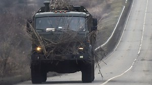 Russian Military Uses Wood Logs for Armor on Convoy Trucks