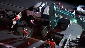 Preparations are underway for one of Dark MOFO's more controversial performances this year: a hole is dug in Macquarie Street, where artist Mike Parr will be entombed for 72 hours while traffic drives over the top of him. | ABC Hobart