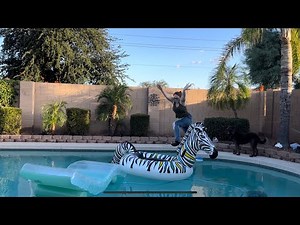 Attempting to do a flip into the pool fully clothed