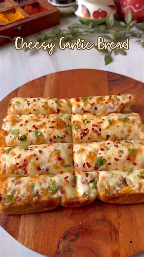 Shashi on Instagram: "✨ Cheesy Garlic Bread ✨ Cheesy Garlic Bread is the ultimate comfort snack: warm, crusty bread loaded with a buttery garlic spread and topped with a gooey blend of melted cheeses. The edges get crisp and golden, while the center stays soft, rich, and full of flavor. Perfect as a side for pasta, soups, or enjoyed all on its own, this is a crowd-pleasing treat with irresistible aroma and taste. . . . #cheese #garlicbread #sandwich #garlic #cheesy #food #reels #reelitfeelit #fo