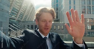 Suited blogger engages camera with intense emotions recording compelling video Blogger's face mirrors sentiment gestures accentuating impact. Nuance of blogger's emotional state is visible.