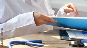 Doctor reading medical documents for medical research. Medical doctor is reading a report about patient in the hospital