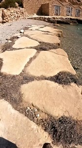 In Spain, this hidden gem is a secluded, horseshoe-shaped bay in northern Ibiza, framed by steep cliffs and dotted with traditional fishermen’s stone shacks, offering some of the island's most transparent and tranquil snorkeling waters. #travel #spain | Spain Hidden Gems