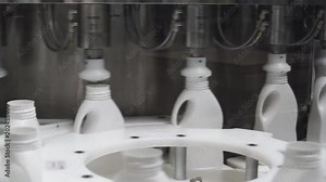 Mass production of plastic bottles. Clip. White plastic milk bottles on the conveyor on a modern dairy plant