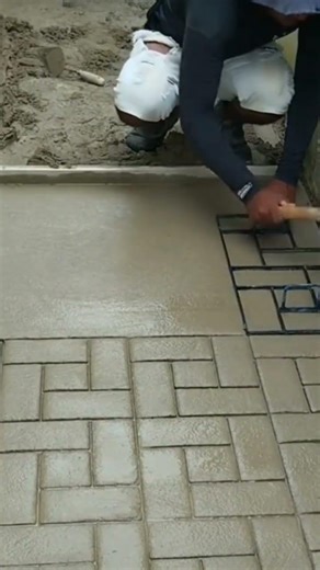 Creating a paving block pattern floor with cement,crafted neatly for a strong and visually appealing