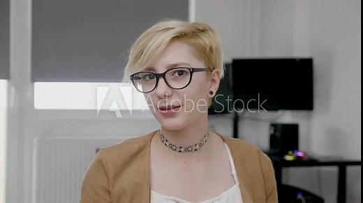 Provocative and seductive young blonde secretary with glasses flirting in the office