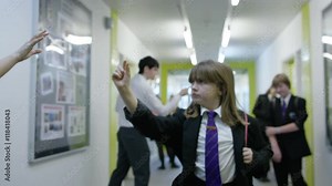 Frozen in time - teachers & pupils in still positions in school corridor