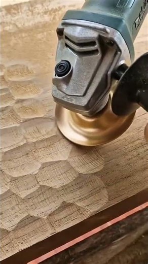 using a power angle grinder with a carving disc to create textured patterns on a wooden surface