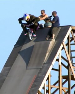 Travis Pastrana takes one-upping to a whole new level as he attempts to backflip a tricycle from a monstrous mega ramp. | Nitro Circus