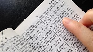 Close up woman reading bible at home