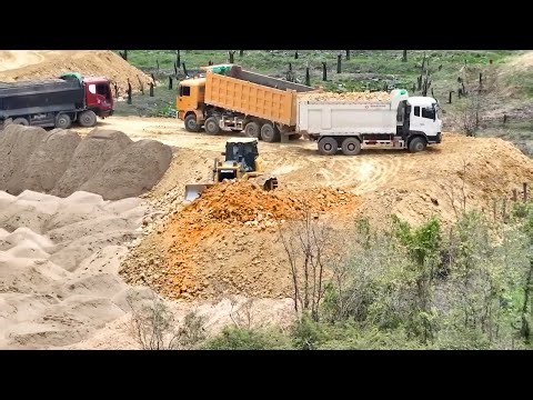 Start construction project using SHANTUI bulldozers to push soil into rice fields