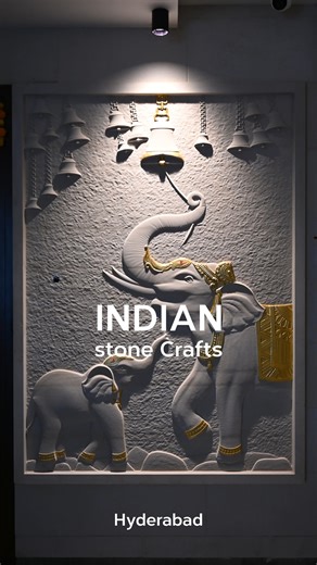 INDIAN STONE CRAFTS on Instagram: "This sculpted stone wall panel features a graceful elephant and calf, adorned with subtle gold accents and temple-inspired bells, creating a serene, devotional ambience. The soft relief work and textured background add depth while maintaining a minimalist white palette that suits contemporary interiors. Warm focused lighting highlights the intricate carving, turning the artwork into a striking focal point for foyers, living rooms, mandir spaces or hotel lobbies