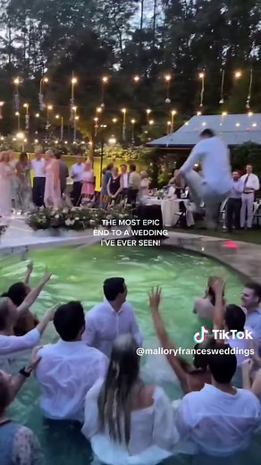 Bride Smiling in Pool at Wedding Reception