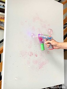 318K views · 3.5K reactions | I had this fun idea during my flight to paint with a bubble gun. Once I got back to my studio, I experimented mixing a few drops of liquid acrylics into the bottle of watered soap and this happened.. what do you think? Have you tried something new in your artwork? Art materials I used are available at www.colorbyfeliks.com | Feliks K | Facebook