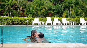 Young couple kissing, swimming and have a fun in the swimming pool. slow motion. 1920x1080