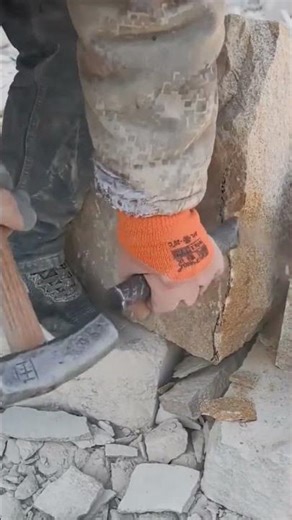 Careful Chiseling Technique for Removing Stone from Wall Base