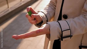 Woman applying an antibacterial antiseptic hand gel for hands disinfection.