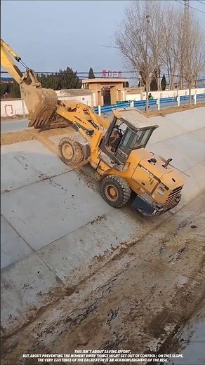 Excavator assists loader in climbing steep slope