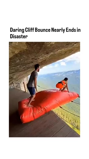 Rare Folio on Instagram: "The post shares a 10-second video of a woman bouncing on a large red inflatable positioned on a cliff edge, narrowly avoiding a plunge into the valley below, captioned to highlight the near-disaster. With over 4.4 million views and 1.8k likes in under 24 hours, it has sparked debate in replies, where users frequently call it 'AI slop' due to unnatural motion and physics, though the author dismisses such claims. This clip aligns with a trend of hyper-realistic AI-generat