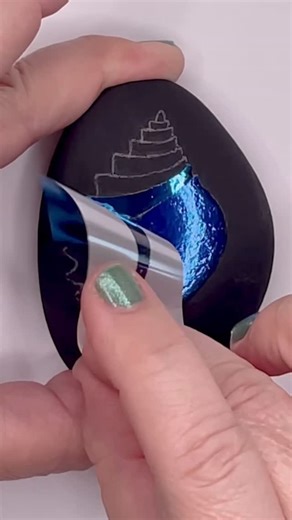 Kala Escobar Design on Instagram: "A fancy shell… 🐚🌊✨ My Deluxe Foil kits are in stock and come with everything you need to try this technique…including a video tutorial! #artsupplies #foil #rockpainting #crafty"