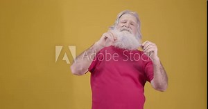 Video of elderly man yawning on yellow background. Tired old man yawning from sleep. 4k