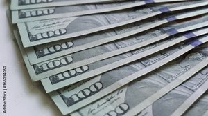 Cash money background. Benjamin Franklin portrait on 100 US dollar bill close up, the image is rotated.