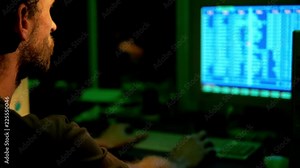 Programmer hacks web site defense and firewalls by command console at retro PC in dark room with green light