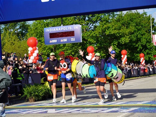 Runners cross finish line at 500 Festival Mini-Marathon