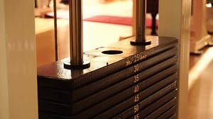 close up of weight stack from a cable exercise machine. Gym and workout equipment for training in 4k.