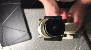 man using a microscope