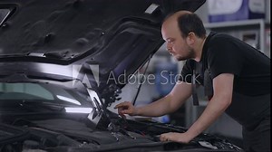 Chip Tuning Machine, Master Checker with Computer Under Hood Conducts Chip Tuning and Flashing Machine