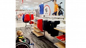 2-year-old boy in wheelchair gazes at Target ad featuring boy like him