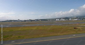 Flying above the runway on Honolulu International Airport (Daniel K. Inouye International Airport). View from helicopter. Oahu island, Hawaii