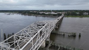 Aerial slow push over steel swing bridge in Beaufort SC, South Carolina to reveal downtown Beaufort