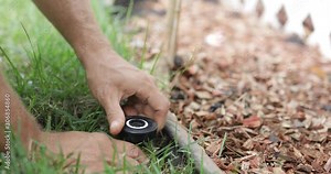 Grass Field Sprinklers Installation by Professional Caucasian Garden Systems Installator. Adjusting Lawn Sprinkler.