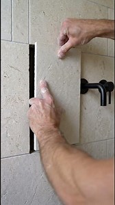 Cracked limestone tile? Watch this clean replacement bring the wall back to life!