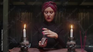 Old senior woman fortune teller shuffle the cards and prepare them to future telling