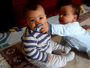 Twin baby boys fight over pacifier