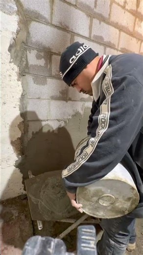 More Portland cement mix right out the bucket to continue to parge the wall #construction #hardwork