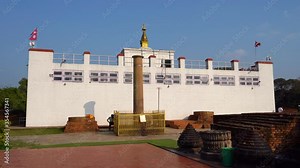 A view of the pillar established by King Ashoka in Lumbini at the birthplace of Siddhartha Gautama, who later became Buddha Shakyamuni. In the background is the Mayadevi temple.